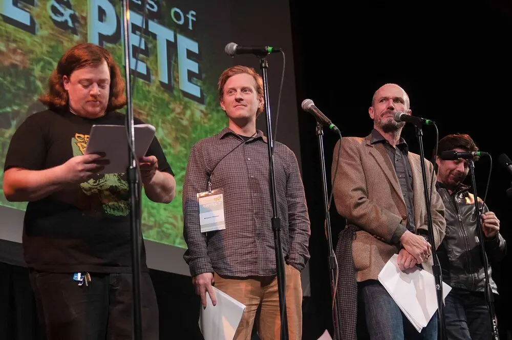 Four performers at microphones on stage at SF Sketchfest 2016, with the show's title projected behind them